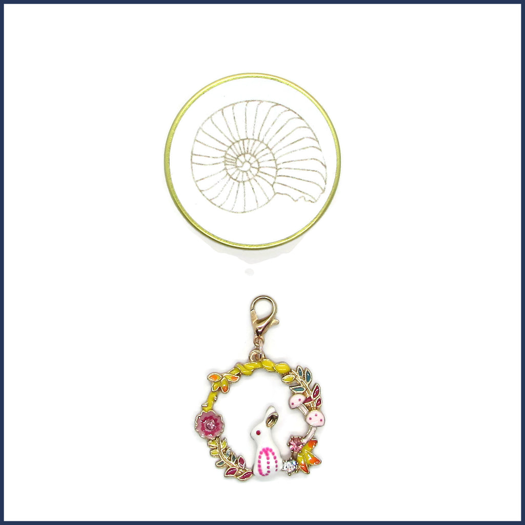 clip-on bunny stitch marker with gold ammonite tin