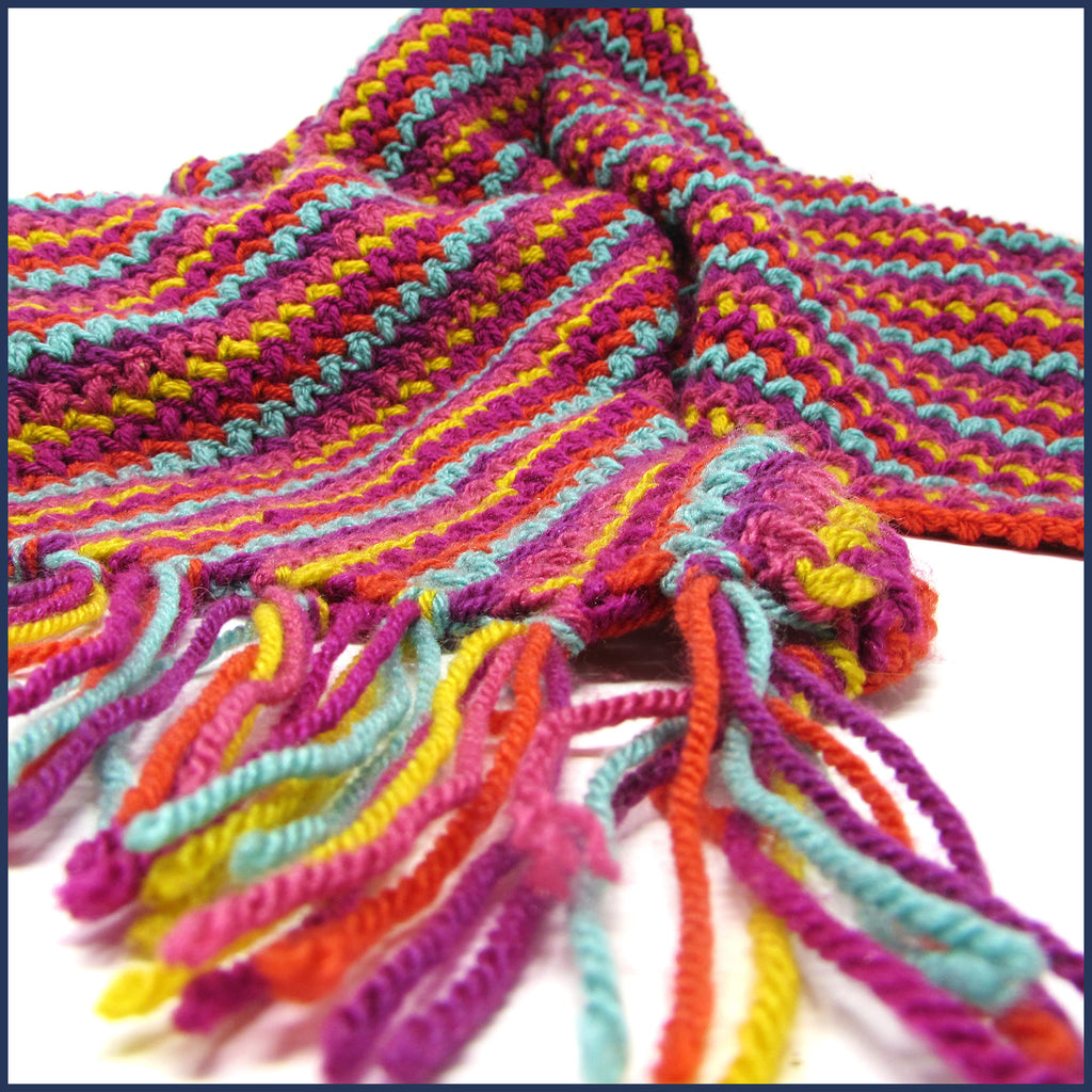 stripey crochet blanket with tassels