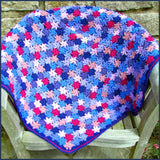 crochet flower blanket on a garden chair