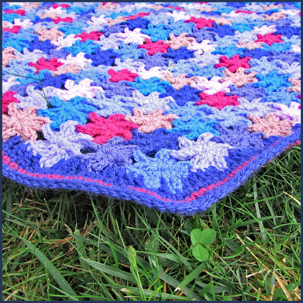 crochet flower blanket on grass