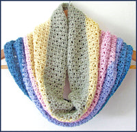 crochet cowl draped on a clothes hanger