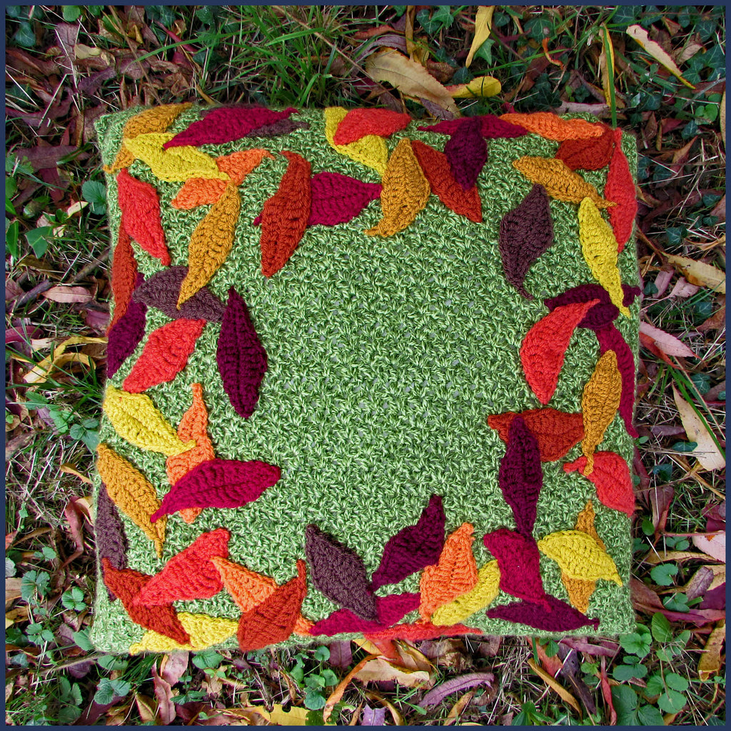 crochet cushion with leaf pattern on a lawn