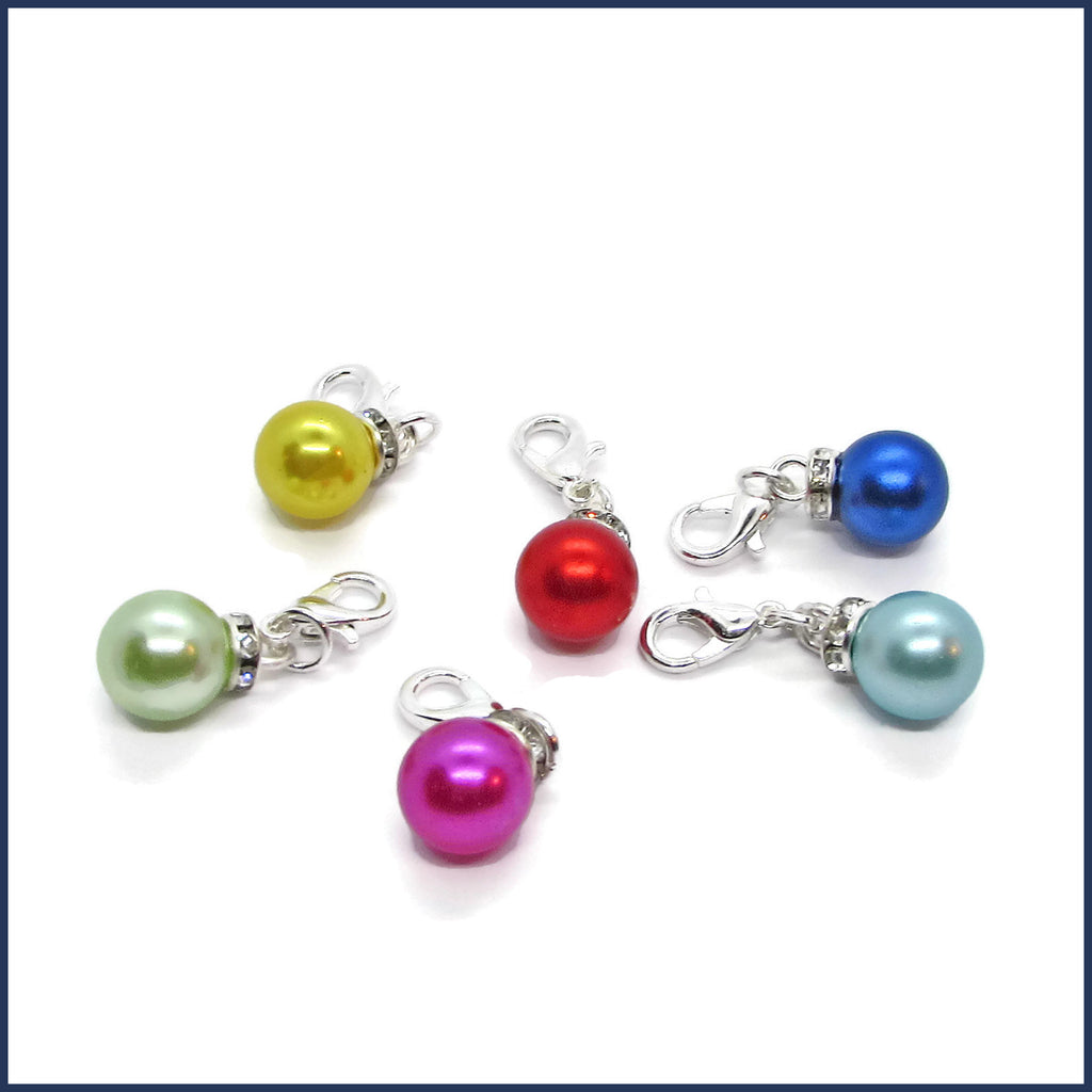 six colourful Christmas ornament stitch markers