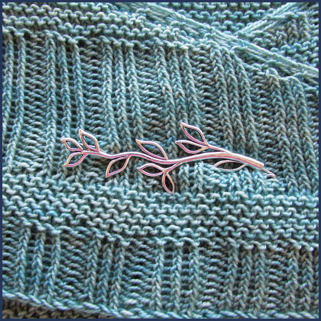 silver twig shawl pin/brooch on knitted fabric