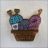 basket of knitting and crochet yarn pin badge on a canvas bag
